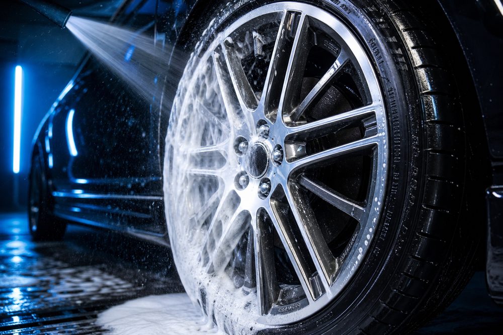 Freshly cleaned alloy wheel being rinsed
